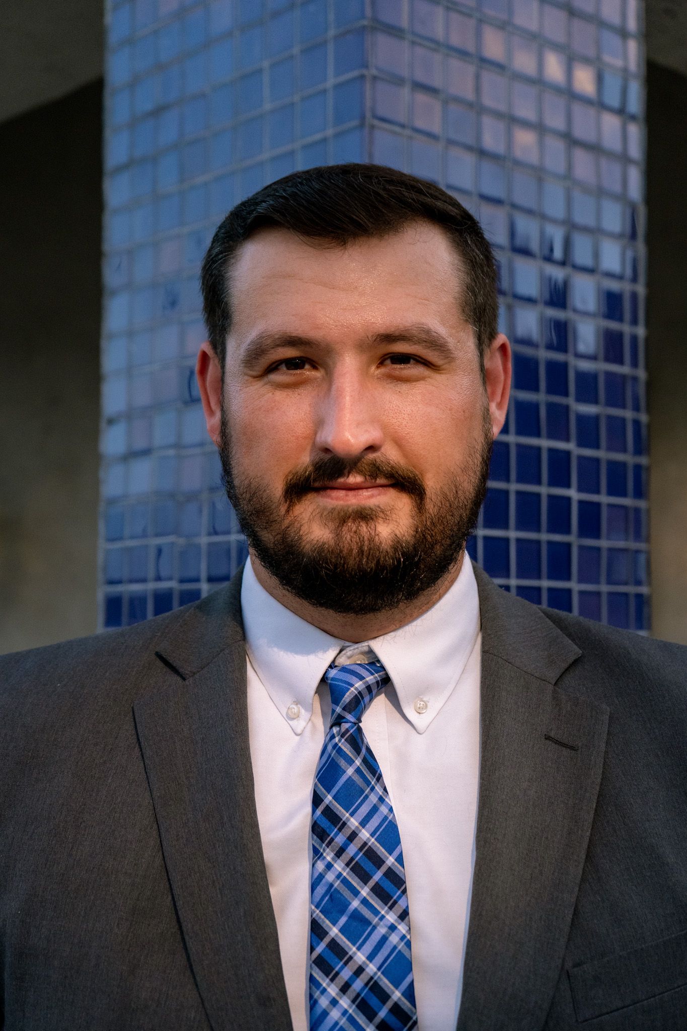 Andrew Kump headshot blue tile